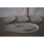 A continental porcelain fish set with large dish and six smaller oyster shaped dishes decorated with