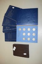 Small photograph album and a boxed collection of coins