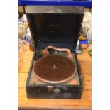 A vintage gramophone player in original case together with a vintage telephone marked AP12932