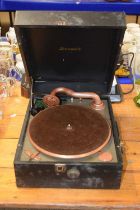 A vintage gramophone player in original case together with a vintage telephone marked AP12932