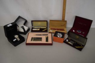 Quantity of boxed modern wristwatches and writing sets