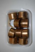 Small box containing a quantity of brass napkin rings