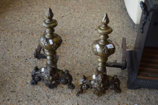 A pair of ornamental fire dogs with moulded decoration