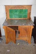 An early 20th Century Art Nouveau pine marble topped wash stand with tiled splash back