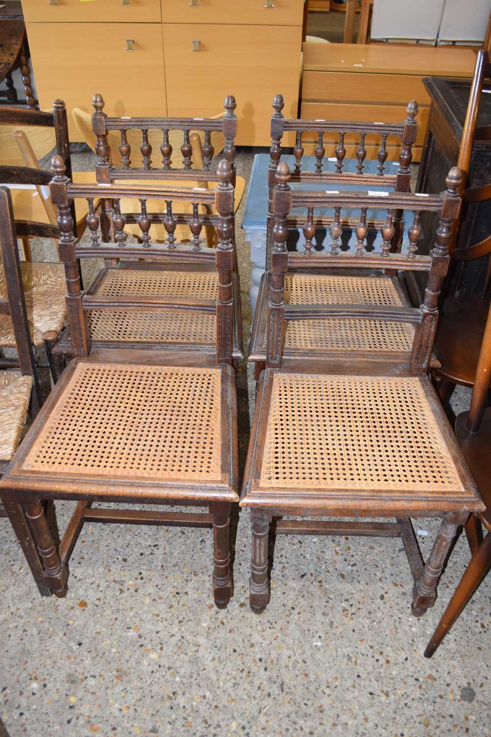 A set of four cane seated 19th Century dining chairs