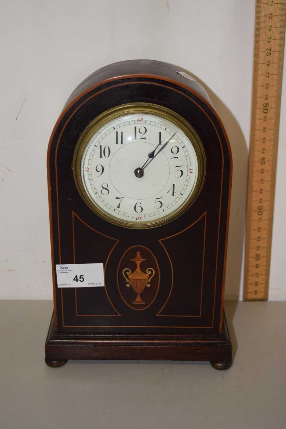 An Edwardian mantel clock with vase inlay