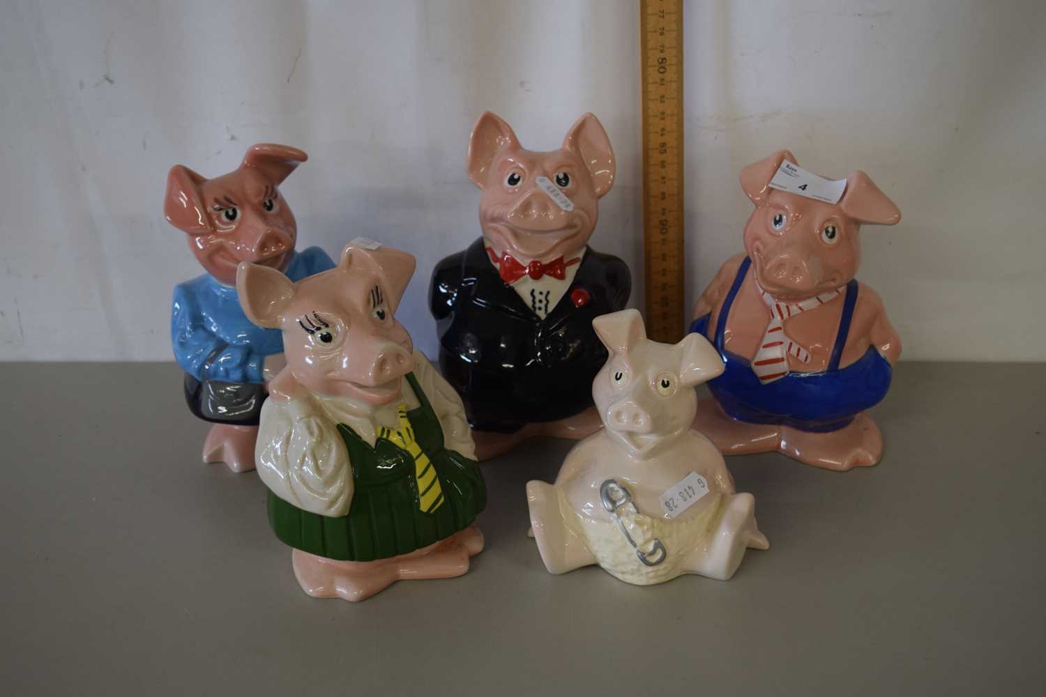 A group of five Wade pig money boxes including a baby pig