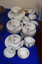 An English porcelain part tea set with a printed floral and bird design comprising cups, saucers,