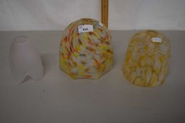 A group of three lampshades, two with a mottled multi-coloured designs