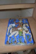 An interesting glazed tile decorated with a man on horseback