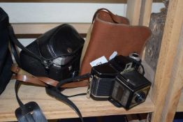 A cased Mamiya 35mm camera together with a Coronet Cadet camera