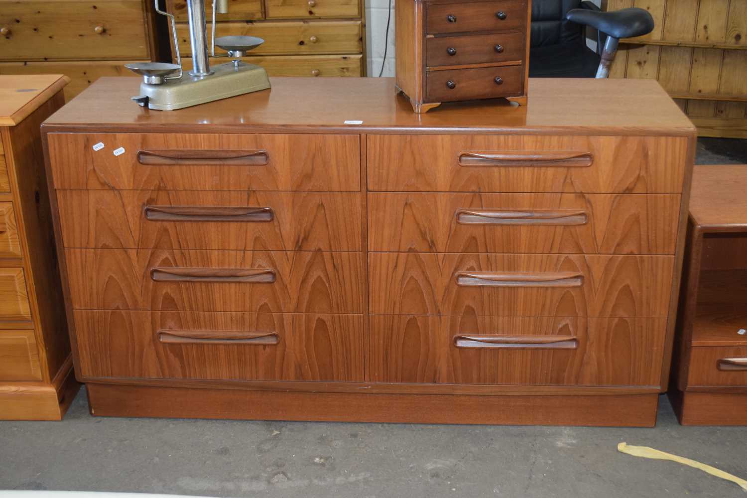 An eight drawer G-Plan low chest together with a similar television stand or entertainment unit