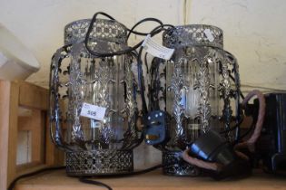 A pair of decorative metal framed hanging lamps