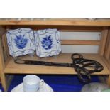 Pair of modern Delft style decorative plates together with a vintage carpet beater