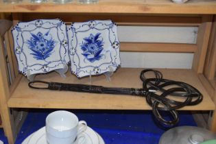 Pair of modern Delft style decorative plates together with a vintage carpet beater