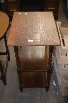 An oak occasional table with turned legs and shelf beneath