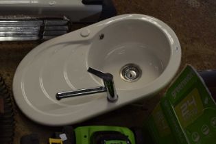 Ceramic sink together with a mixer tap