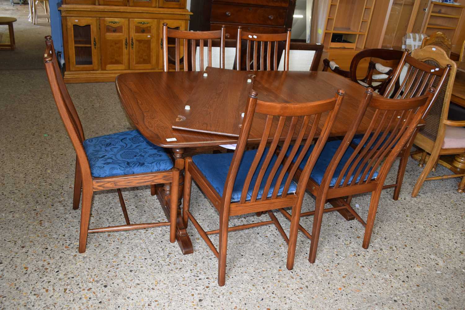 A dark Ercol extending dining table and six chairs