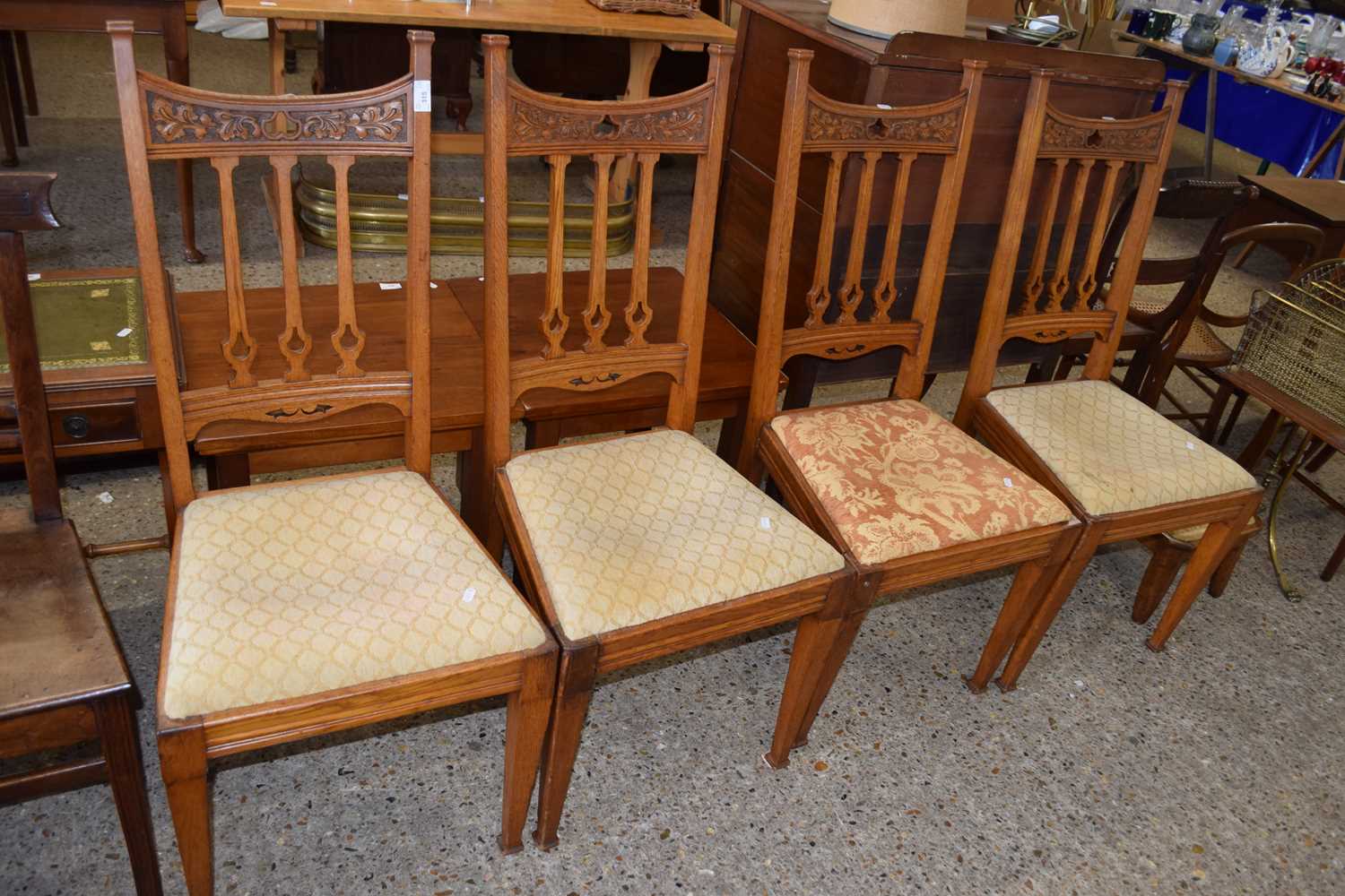 A set of four late 19th Century Arts and Crafts style oak dining chairs