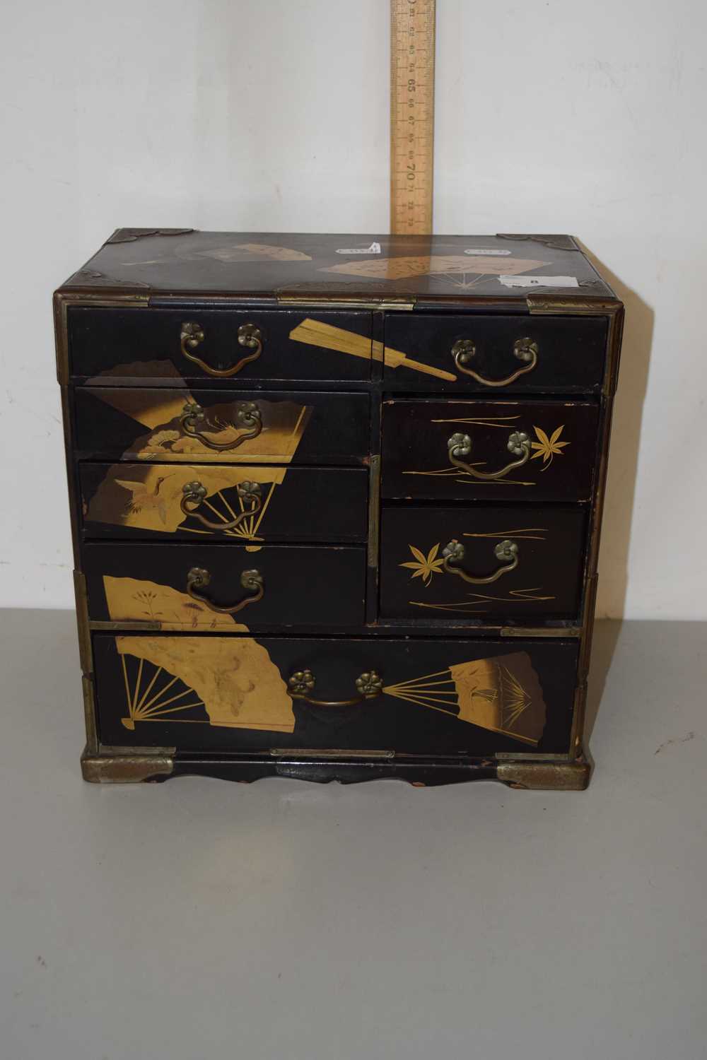 An Oriental black lacquered table top cabinet