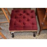 A button upholstered footstool