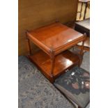 A reproduction yew wood veneered bedside cabinet with pull out slide