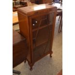 An early 20th Century mahogany veneered bookcase cabinet with a glazed door and cabriole legs