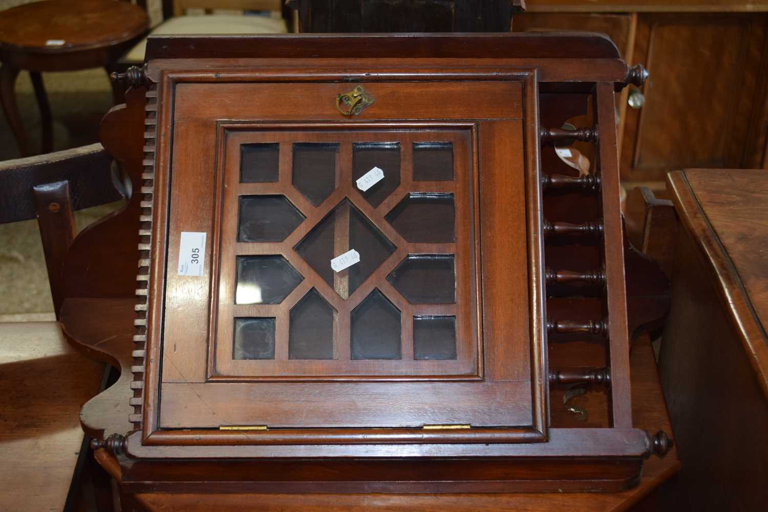 A late 19th Century mahogany wall mounted corner cabinet with glazed door