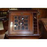 A late 19th Century mahogany wall mounted corner cabinet with glazed door