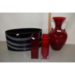 Two rectangular shaped ruby red glass vases together with a large amphora type glass vase, largest