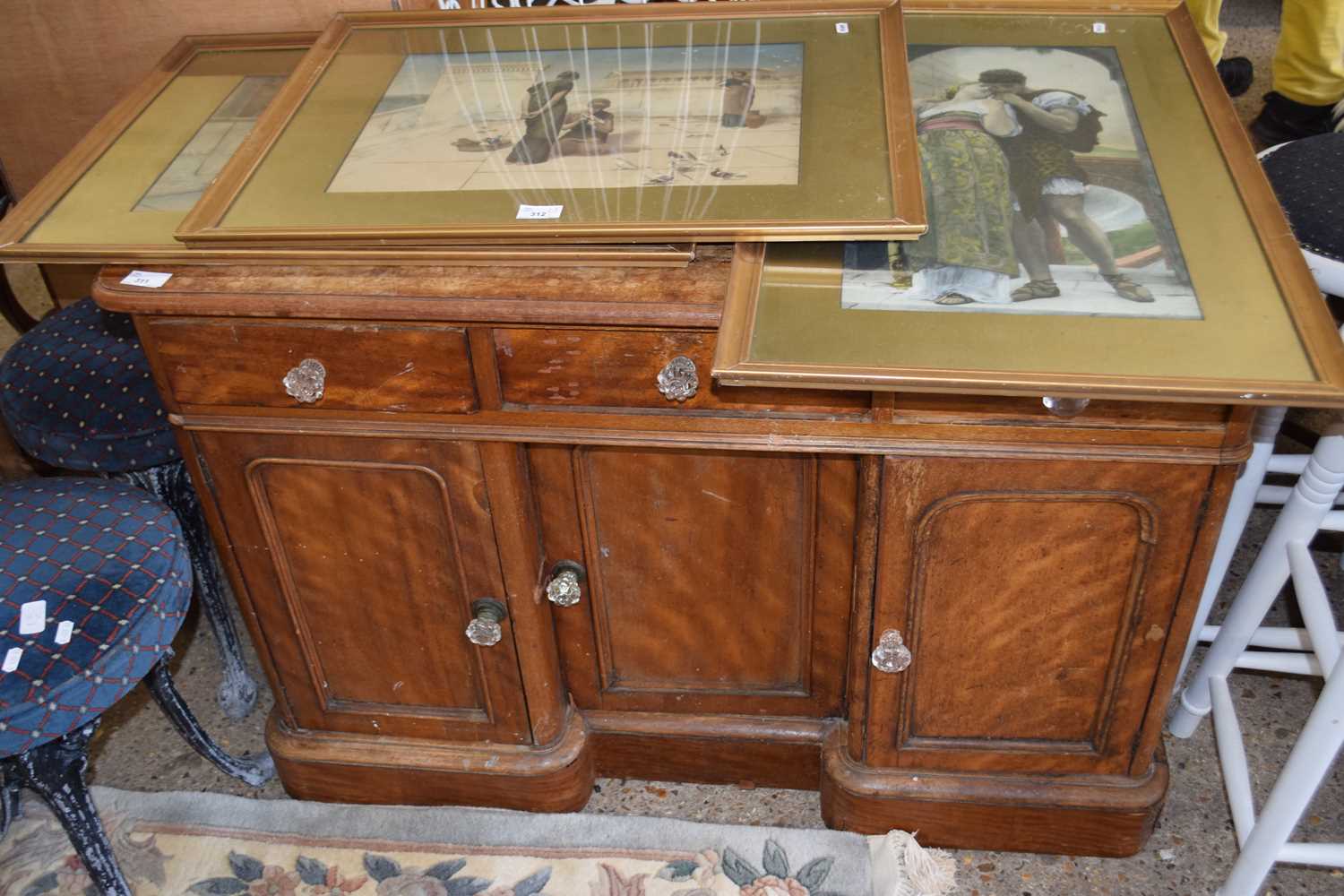 A Victorian mahogany side cabinet with three drawers and three doors