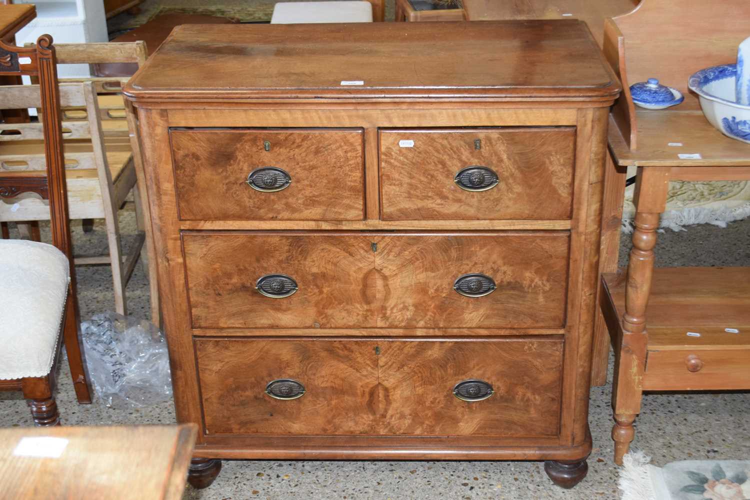 Late Victorian walnut veneered four drawer chest with oval brass handles