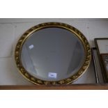 A modern circular bevelled wall mirror