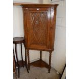 Georgian oak corner cabinet with later carving and stand
