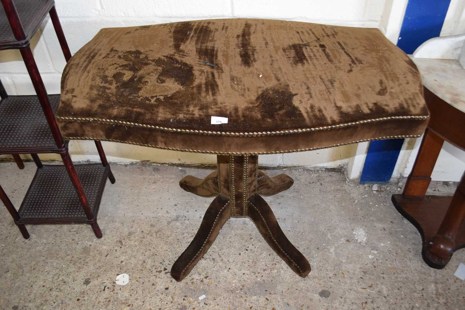 An upholstered pedestal table