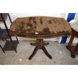 An upholstered pedestal table