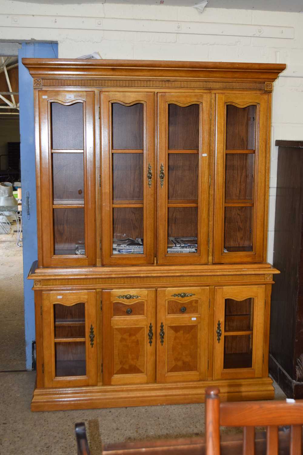 A modern oak lounge display cabinet with glazed top section