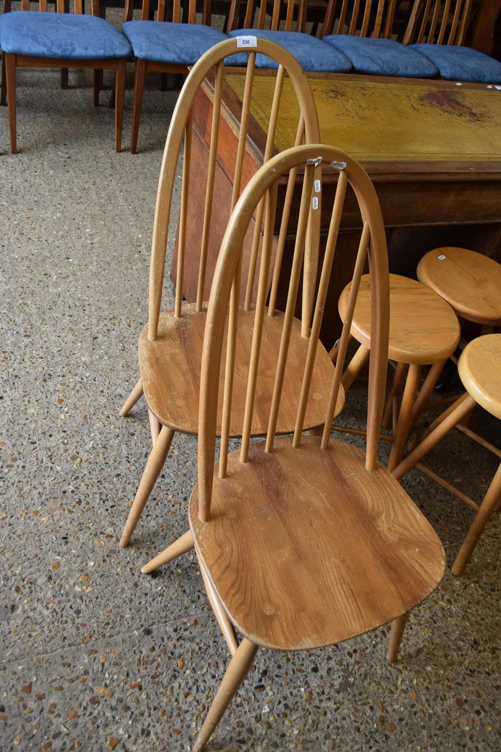 A pair of Ercol light elm stick back dining chairs