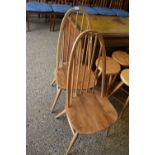 A pair of Ercol light elm stick back dining chairs