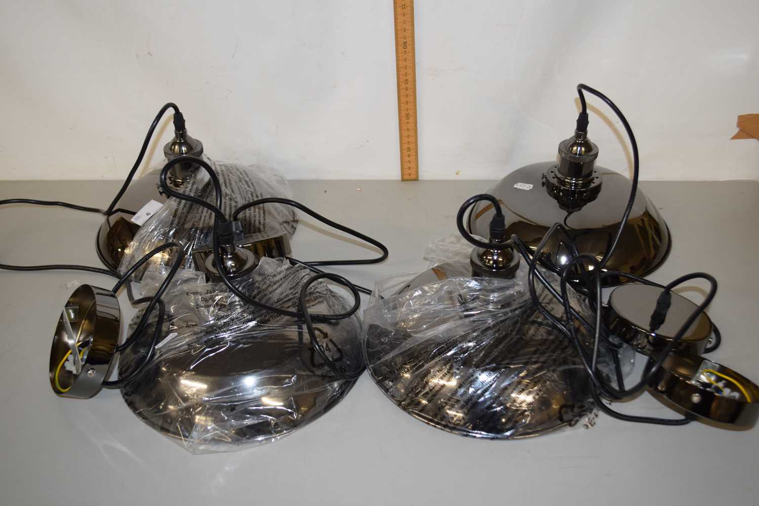 A group of four as new industrial style pendant light fittings
