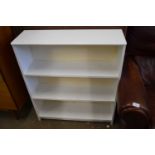 A white four tiered free standing bookshelf