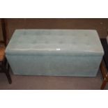 A green velour button upholstered coffer