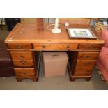 A pine leather topped twin pedestal desk