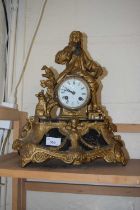 A gilt metal mantel clock
