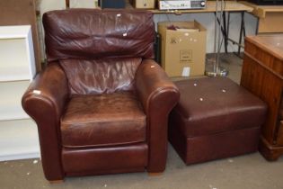 A leather armchair and matching footstool