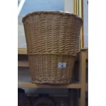 A wicker waste paper basket