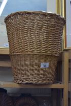 A wicker waste paper basket