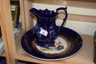A blue and gilt decorated plate together with a blue glazed jug
