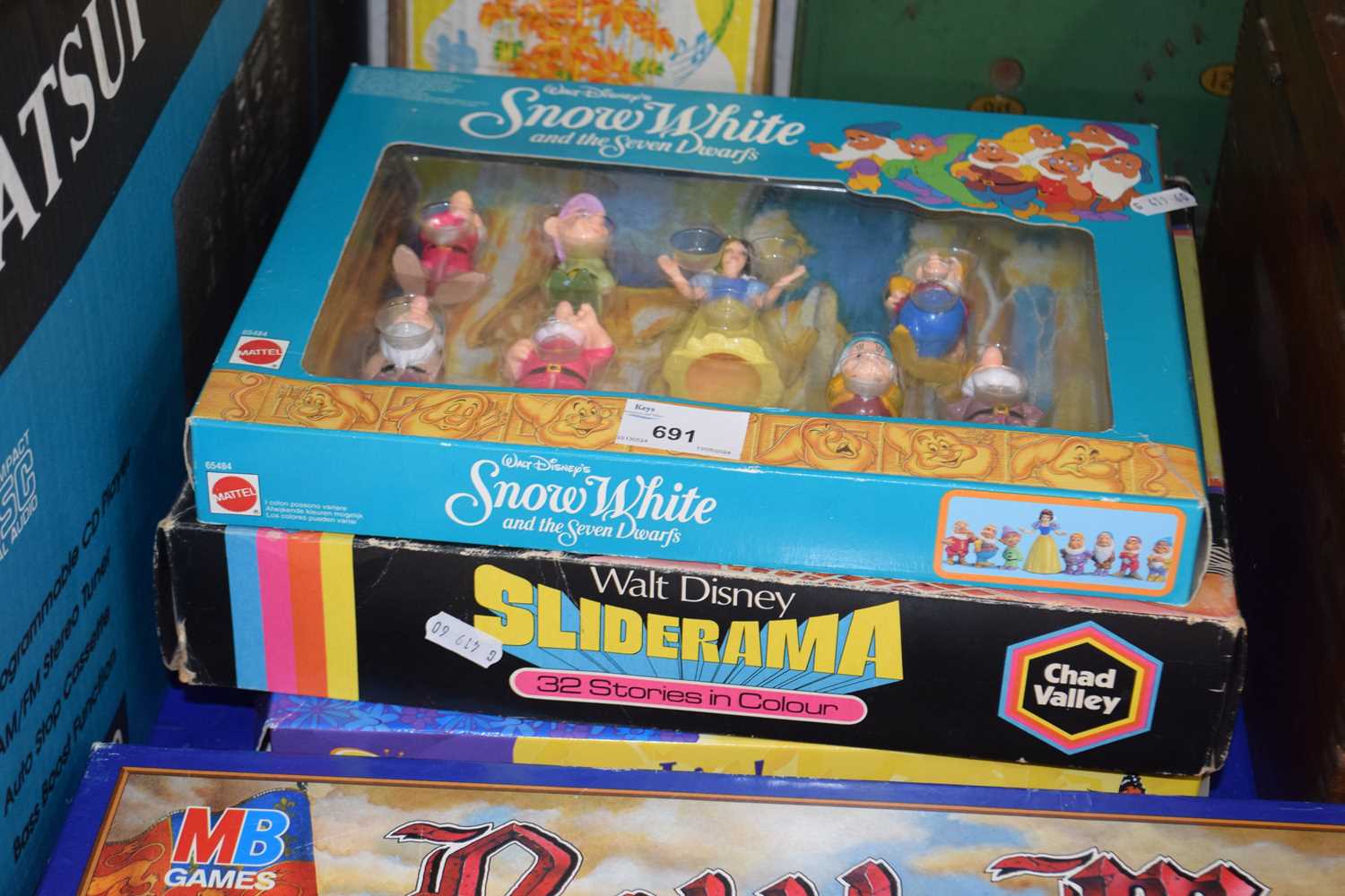 Snow White and the Seven Dwarfs figurines, boxed together with Walt Disney Sliderama and a butterfly