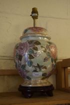 A floral decorated ceramic table lamp